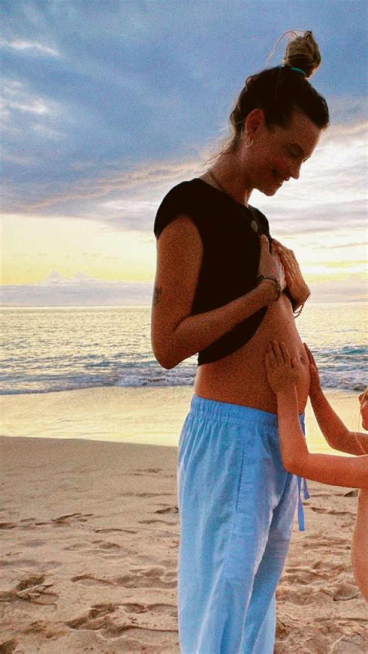 
Behati Prinsloo Shares Cute Baby-Bump Photo, Confirms She’s Expecting Baby No. 3 With Adam Levine 